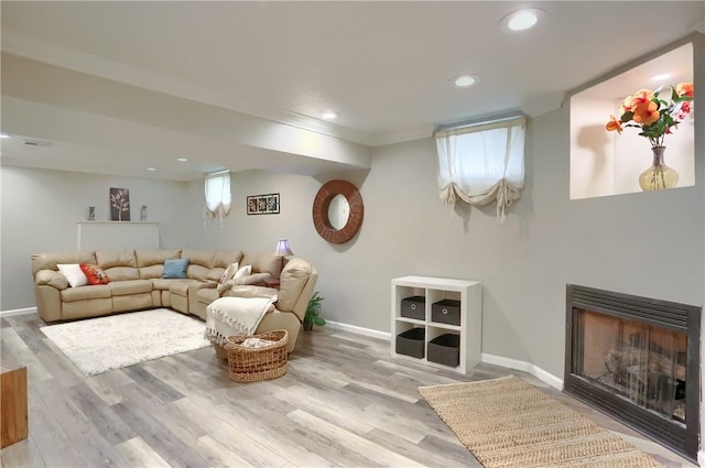 living room featuring crown molding and light wood-type flooring