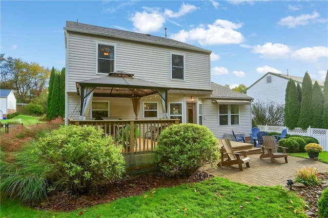 rear view of property with a gazebo and a patio