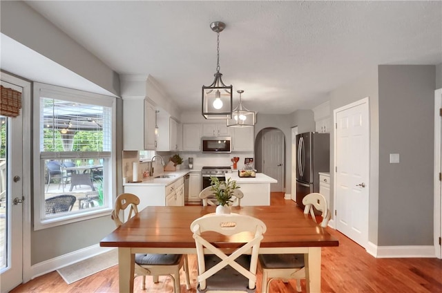 dining room with sink and light hardwood / wood-style floors