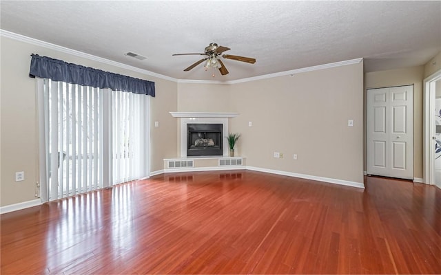 unfurnished living room with crown molding, ceiling fan, hardwood / wood-style floors, and a textured ceiling