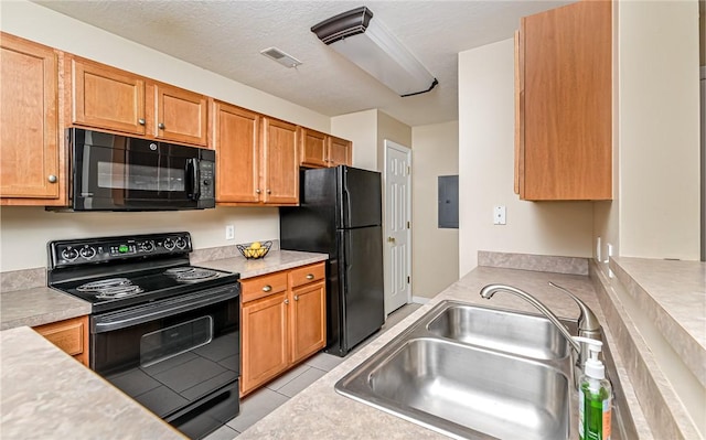 kitchen with sink, light tile patterned floors, electric panel, black appliances, and a textured ceiling