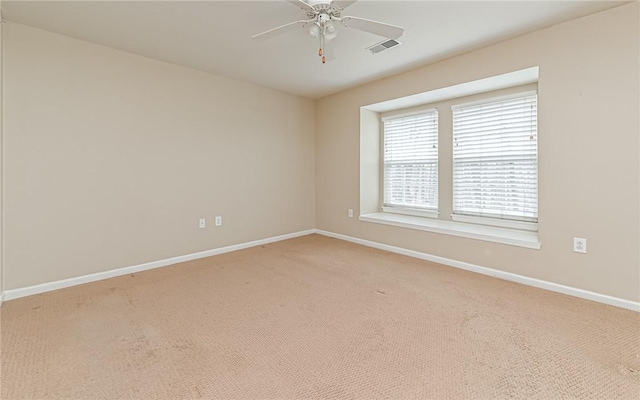 spare room featuring ceiling fan and carpet