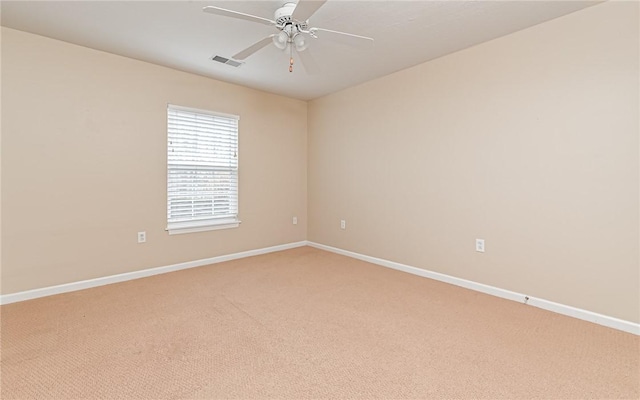 carpeted empty room featuring ceiling fan