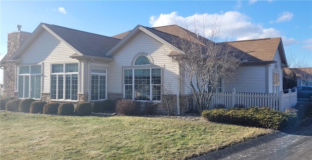 view of side of home with a lawn