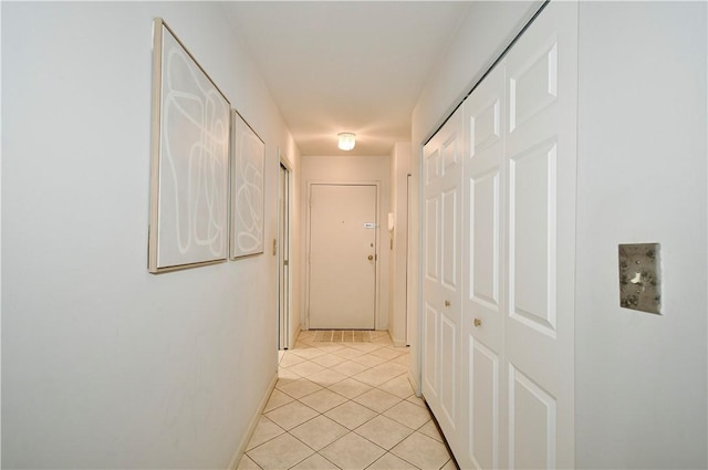 hall featuring light tile patterned floors