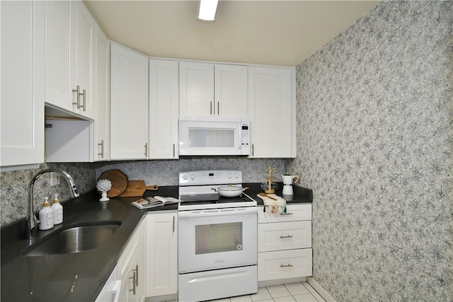 kitchen with sink, white appliances, and white cabinets