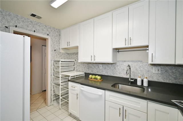 kitchen featuring light tile patterned flooring, white cabinetry, sink, decorative backsplash, and white appliances