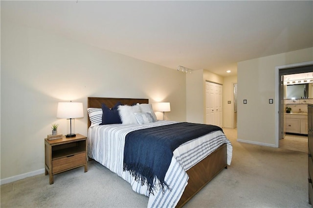 bedroom with a closet and light carpet