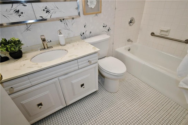 full bathroom with tiled shower / bath combo, vanity, and toilet