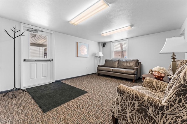 carpeted living room featuring a textured ceiling