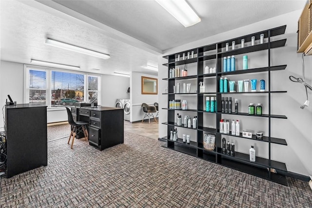 office space featuring washer and dryer, a textured ceiling, and carpet