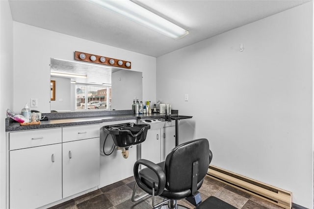 bar featuring white cabinetry and baseboard heating