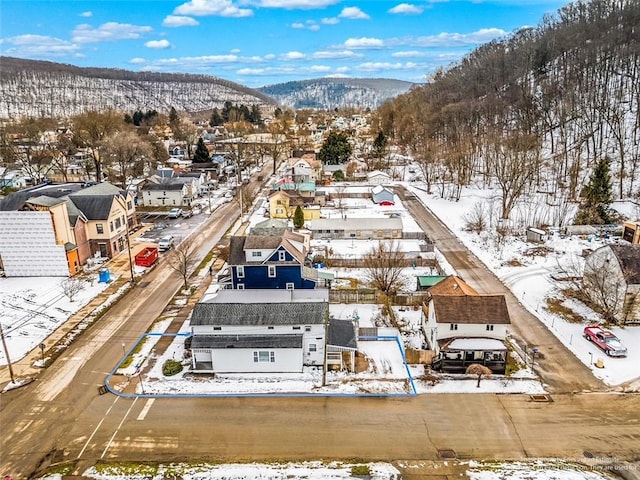 snowy aerial view with a mountain view