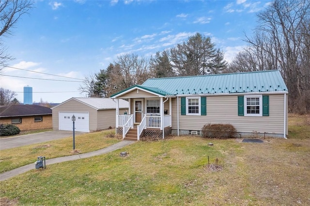 view of front of property with a garage, a front yard, an outbuilding, and covered porch