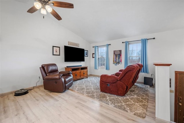 living room with ceiling fan, lofted ceiling, and light hardwood / wood-style floors