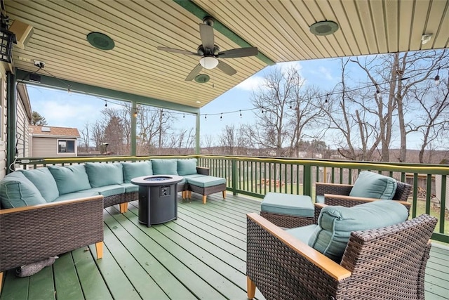 deck featuring an outdoor living space with a fire pit and ceiling fan