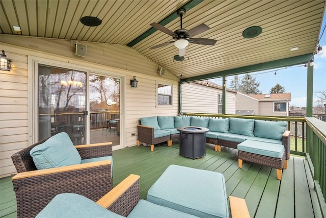 deck with ceiling fan and an outdoor living space with a fire pit