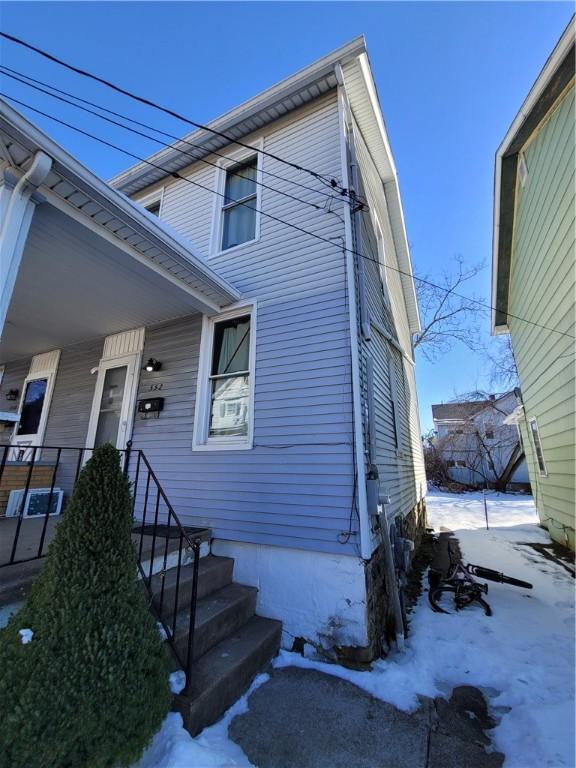 view of snow covered exterior with a porch