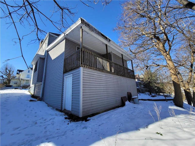 snow covered property with a balcony