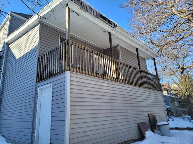 view of snow covered exterior featuring a balcony