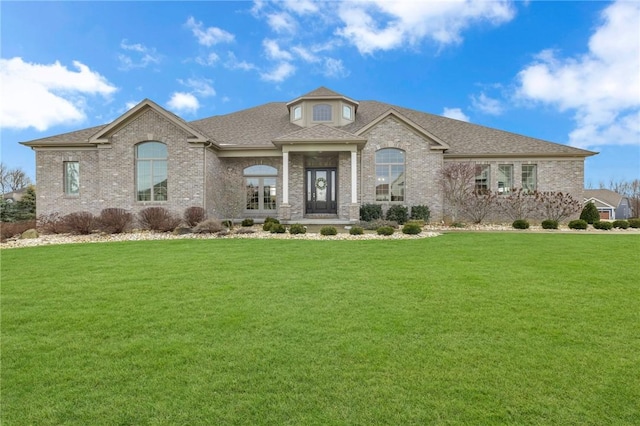 french provincial home with a front yard