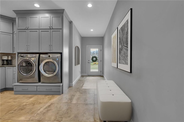 washroom with cabinets and washer and dryer