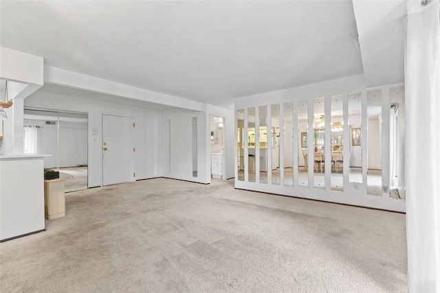 unfurnished living room featuring light carpet