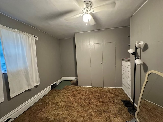 bedroom featuring ceiling fan and dark carpet