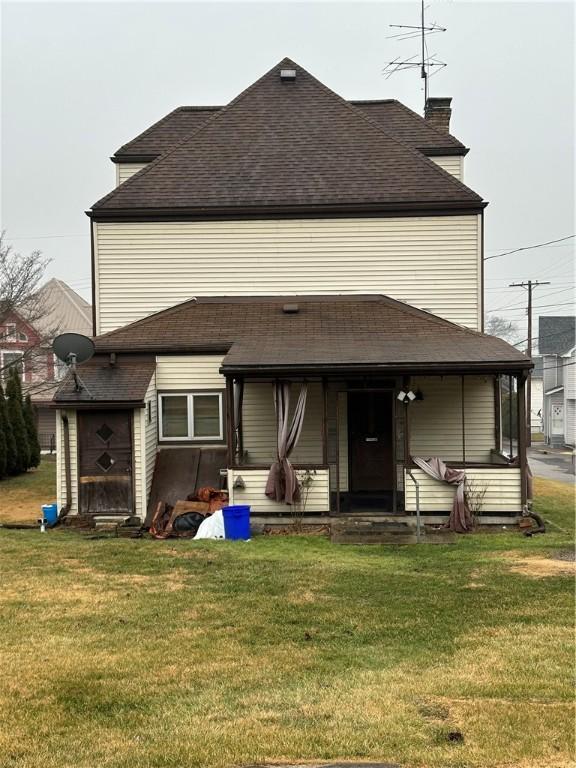 rear view of house with a lawn