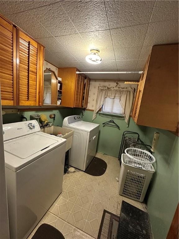 laundry room with cabinets and washing machine and clothes dryer