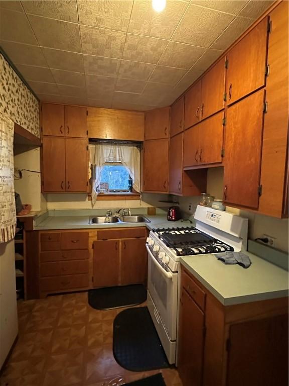 kitchen featuring sink and white gas stove