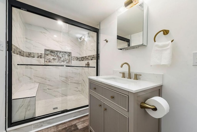 bathroom featuring a tile shower and vanity