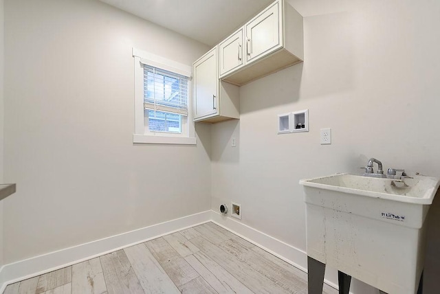 washroom featuring sink, cabinets, light hardwood / wood-style flooring, electric dryer hookup, and washer hookup