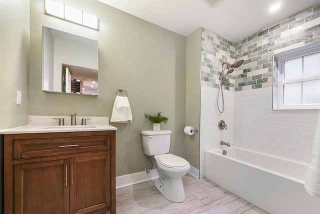 full bathroom with tiled shower / bath, vanity, and toilet