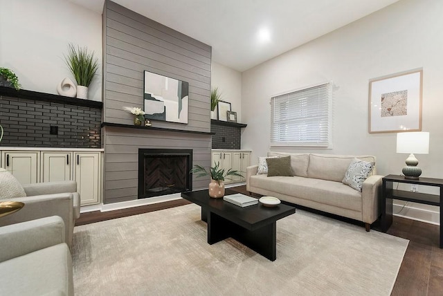 living room with a fireplace and light wood-type flooring