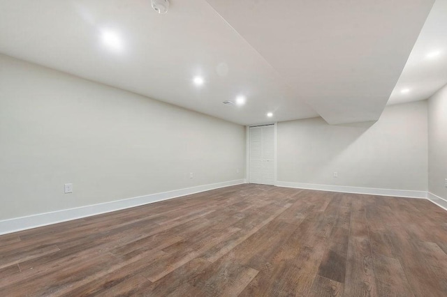 basement featuring dark hardwood / wood-style flooring