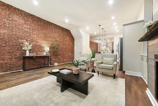 living room with light hardwood / wood-style flooring and brick wall