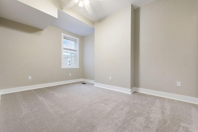 carpeted empty room featuring ceiling fan