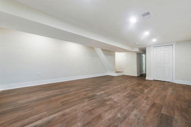 basement with dark hardwood / wood-style flooring