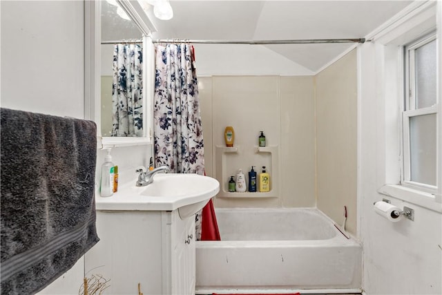 bathroom featuring lofted ceiling, vanity, and shower / tub combo