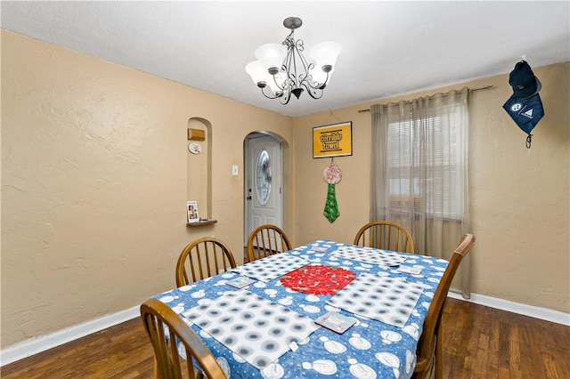 dining room featuring dark hardwood / wood-style floors and a notable chandelier