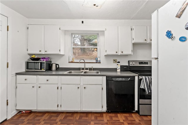 kitchen with white cabinetry, appliances with stainless steel finishes, sink, and dark parquet floors