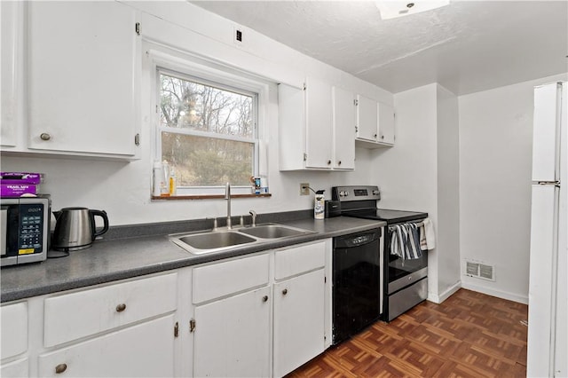 kitchen featuring appliances with stainless steel finishes, dark parquet floors, sink, white cabinets, and a textured ceiling