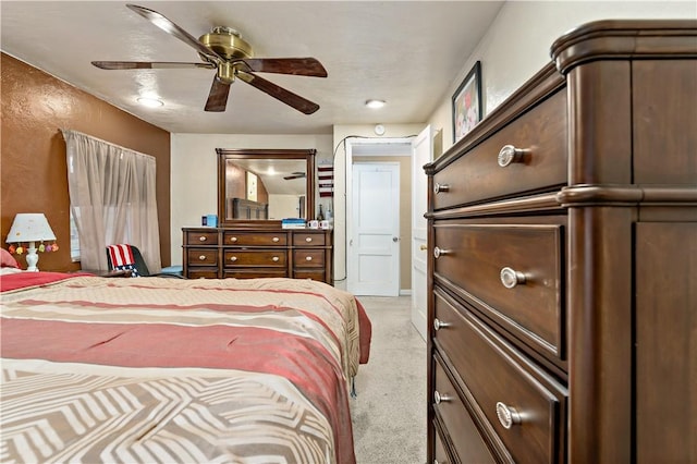 bedroom with light carpet and ceiling fan