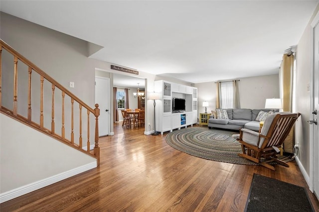 living room featuring a notable chandelier and hardwood / wood-style flooring