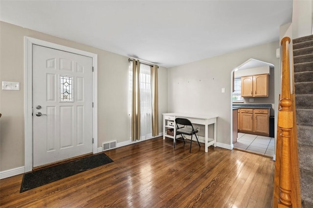 entrance foyer featuring plenty of natural light and dark hardwood / wood-style floors