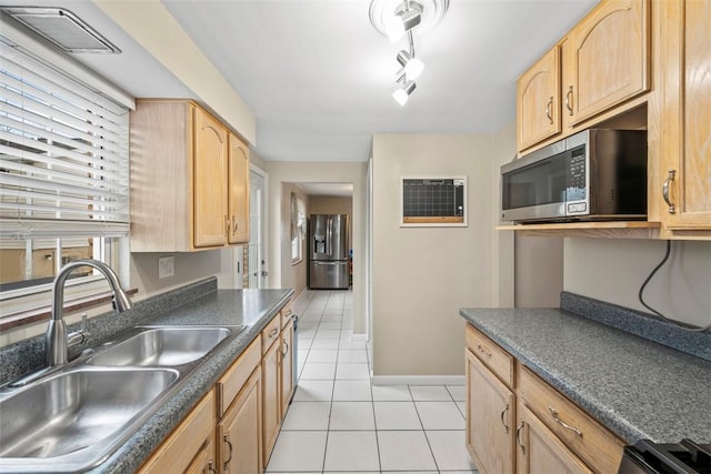 kitchen featuring stainless steel appliances, light tile patterned flooring, sink, and light brown cabinetry