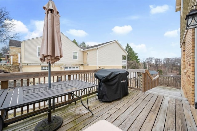 wooden deck featuring area for grilling