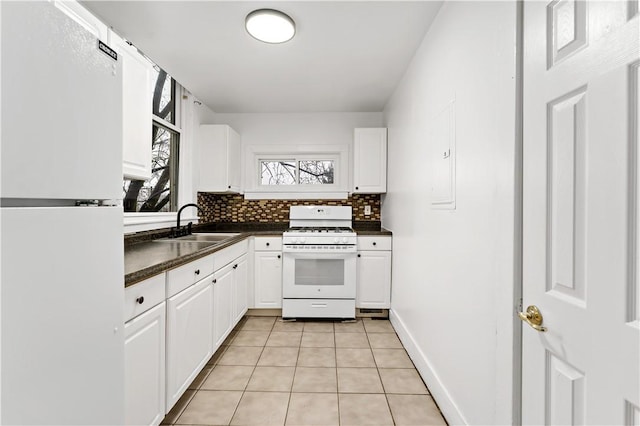 kitchen with white cabinetry, white appliances, sink, and decorative backsplash