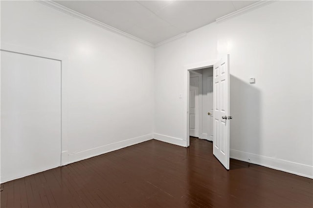 spare room with crown molding and dark hardwood / wood-style floors